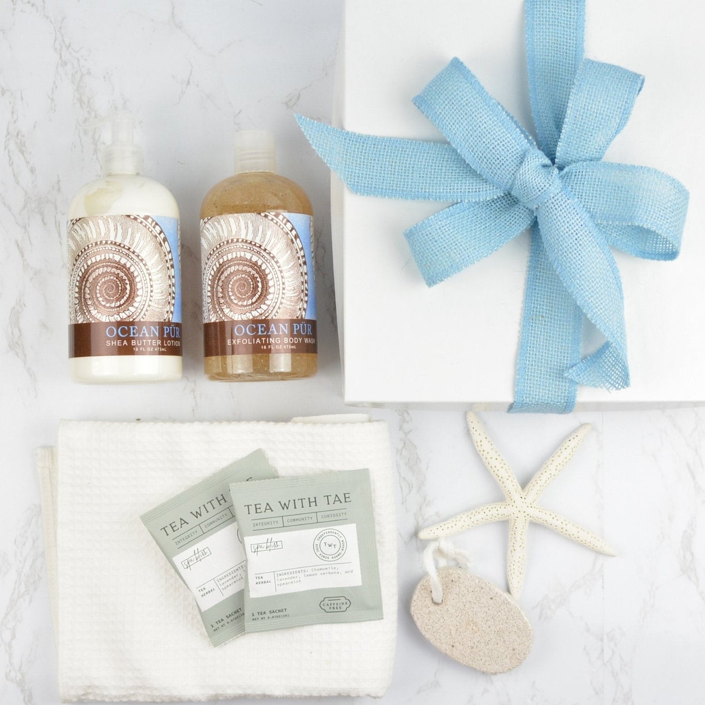 Beach Relaxation Gift Box with ocean-inspired spa products, calming teas, pumice stone, and blue ribbon gift box