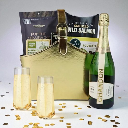 Luxury gold gift basket with Chandon Brut sparkling wine, Pacific Northwest smoked salmon, popcorn, and gourmet snacks — elegant gift option.