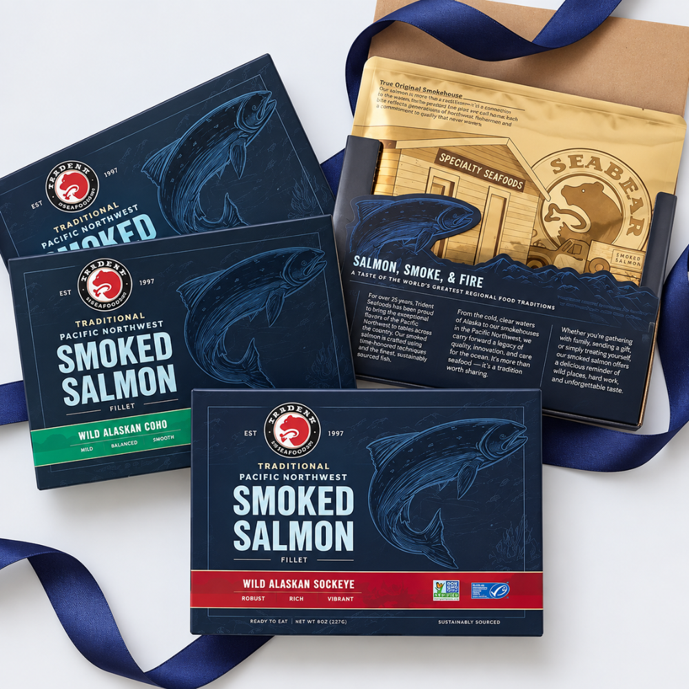 Four packages of Seaborn Traditional Pacific Northwest Smoked Salmon Filletts arranged on a white background with a navy ribbon. The packages are dark blue with white text and a fish illustration, with one package featuring a gold-colored seasoning packet and another with a green accent band.